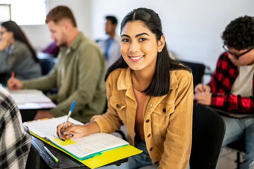 young woman in class taking notes